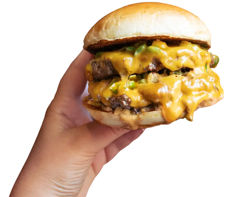 The Melt double meltburger held in one hand